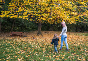 Mom playing with child in leaves