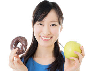 woman with donut and apple