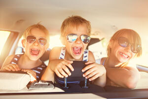 kids with sunglasses on in back of car