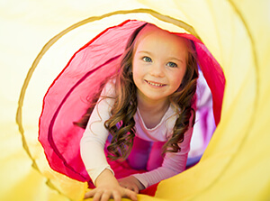little girl playing in tunnel